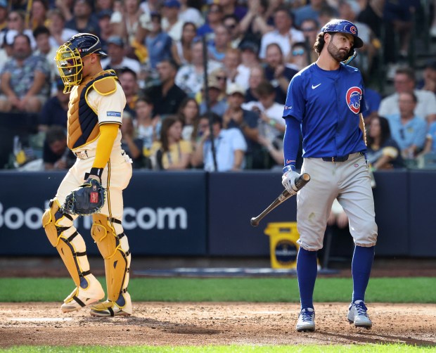 Chicago Cubs shortstop Dansby Swanson walks to the dugout after...