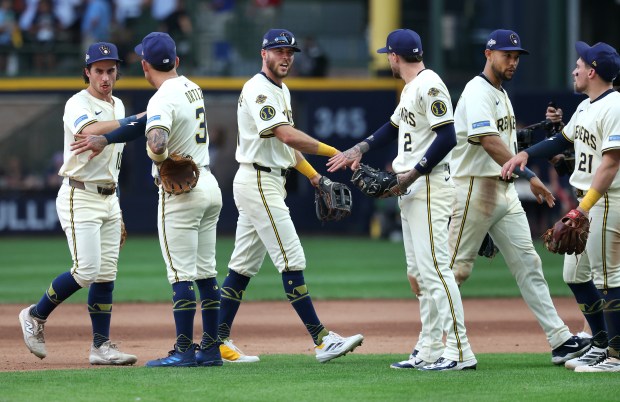 The Milwaukee Brewers celebrate after beating the Chicago Cubs in...