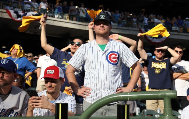 A Chicago Cubs fan looks onto the field as Milwaukee...