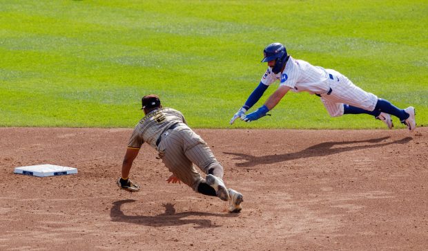 Chicago Cubs shortstop Dansby Swanson (7) dives safely to second...