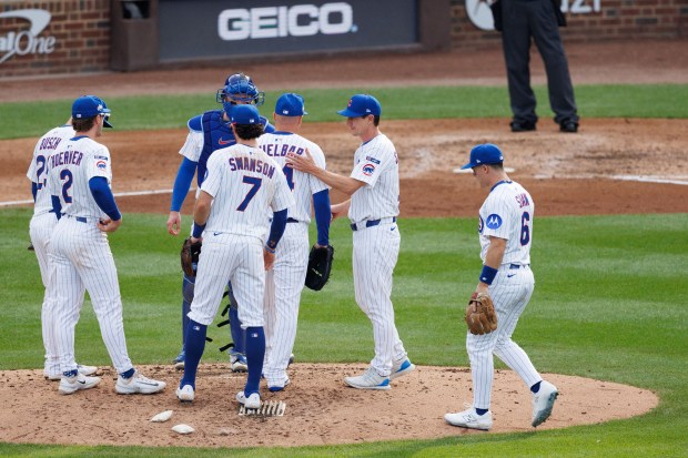 Chicago Cubs manager Craig Counsell (11) takes out Chicago Cubs...
