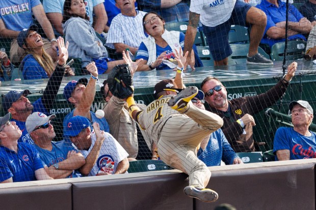 San Diego Padres first baseman Luis Arraez (4) falls while...