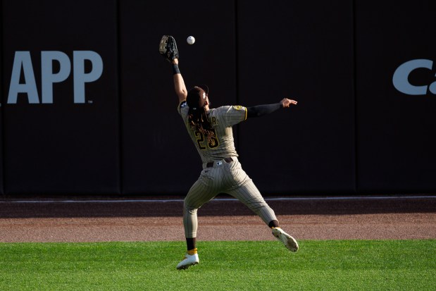Padres right fielder Fernando Tatis Jr. catches a ball from Cubs second baseman Nico Hoerner during the eighth inning of Game 2 of the National League wild-card series Oct. 1, 2025, at Wrigley Field. (Armando L. Sanchez/Chicago Tribune)