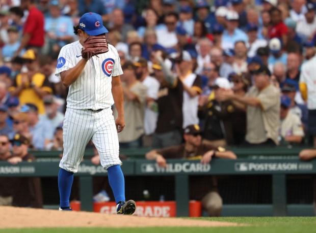Chicago Cubs relief pitcher Shota Imanaga walks back to the...