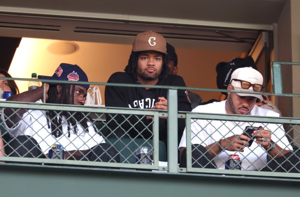 Chicago Bears wide receiver Rome Odunze and his teammates watch...