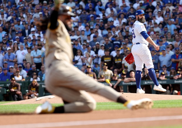 Chicago Cubs starting pitcher Andrew Kittredge watches as San Diego...