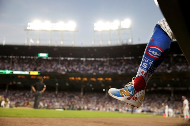 The leg of Cubs relief pitcher Daniel Palencia hangs over...