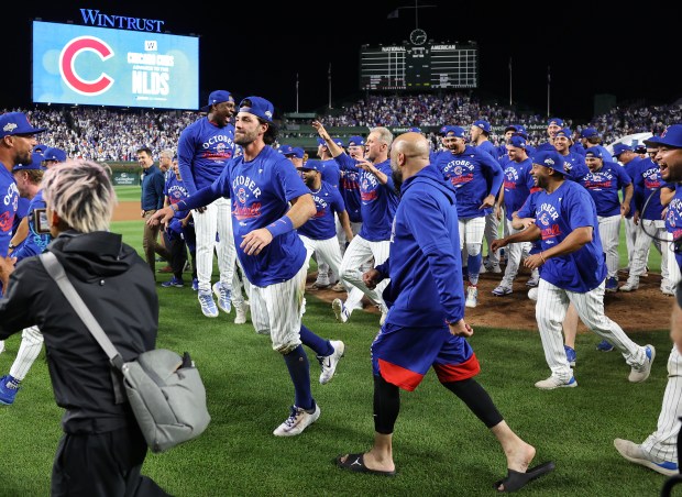 Cubs shortstop Dansby Swanson and the team celebrate after their...
