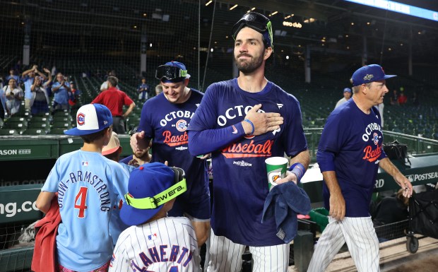 Cubs shortstop Dansby Swanson emerges from the locker room as...