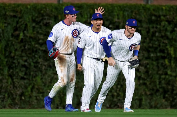 Cubs outfielders Pete Crow-Armstrong, from left, Seiya Suzuki and Ian...