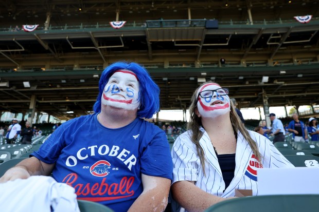 Mike Lyp and his daughter Shelly Lyp take in the scene before Game 3 of the wild-card series between the Chicago Cubs and the San Diego Padres at Wrigley Field, Oct. 2, 2025. (Chris Sweda/Chicago Tribune)