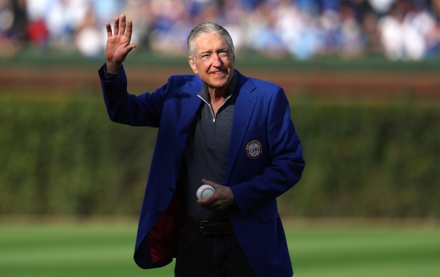 Chicago Cubs radio broadcaster Pat Hughes waves to the crowd before throwing out a ceremonial first pitch before Game 3 of the wild-card series against the San Diego Padres at Wrigley Field in Chicago on Oct. 2, 2025. (Chris Sweda/Chicago Tribune)