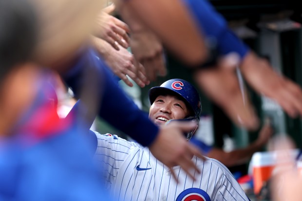 Chicago Cubs right fielder Seiya Suzuki is congratulated in the...