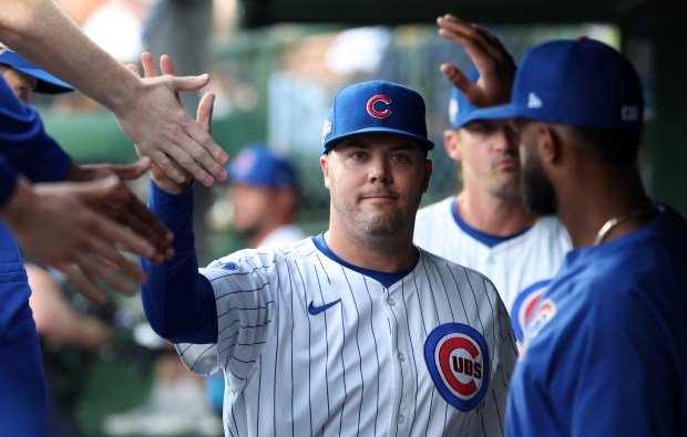 Cubs relief pitcher Caleb Thielbar is congratulated by his teammates...