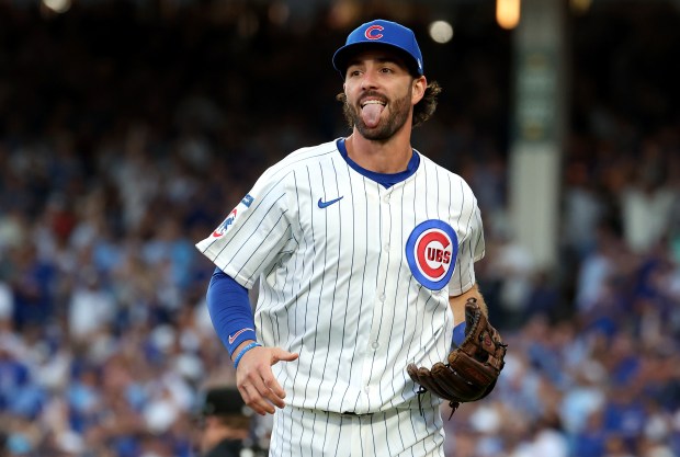 Cubs shortstop Dansby Swanson celebrates after completing a double play...