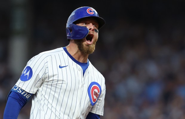 Cubs first baseman Michael Busch celebrates as he rounds the...