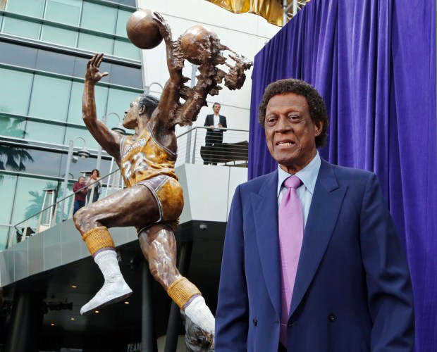 Elgin Baylor stands next to a statue honoring the Lakers great on April 6, 2018, outside the Staples Center in Los Angeles. (AP Photo/Reed Saxon)