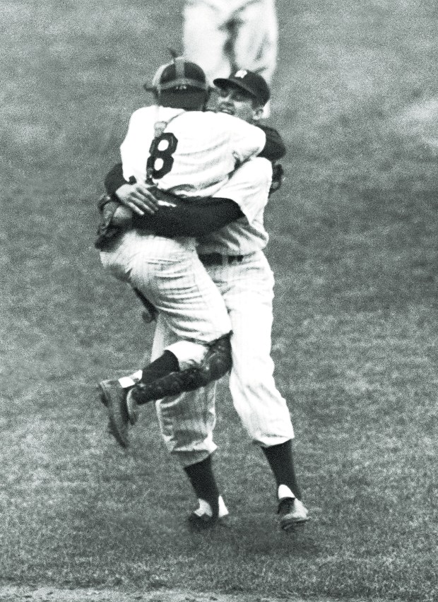 Yankees catcher Yogi Berra leaps into the arms of pitcher Don Larsen after Larsen completed his perfect game during Game 5 of the World Series against the Dodgers on Oct. 8, 1956, in New York. (AP Photo)
