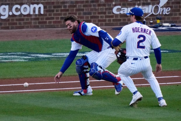 Chicago Cubs' Carson Kelly and Nico Hoerner can't catch a pop up by Milwaukee Brewers' William Contreras during the first inning of Game 3 of baseball's National League Division Series Wednesday, Oct. 8, 2025, in Chicago. (AP Photo/Nam Huh)