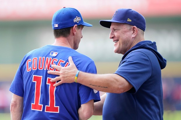 Chicago Cubs manager Craig Counsell (11) and Milwaukee Brewers manager Pat Murphy, right, shake hands before Game 1 of baseball's National League Division Series, Saturday, Oct. 4, 2025, in Milwaukee. (AP Photo/Kayla Wolf)