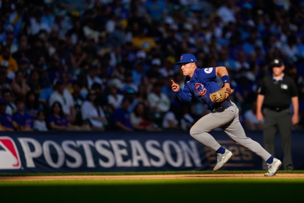 Chicago Cubs third baseman Matt Shaw attempts to make it to third base before the steal by Milwaukee Brewers' Christian Yelich during the eighth inning in Game 1 of baseball's National League Division Series, Saturday, Oct. 4, 2025, in Milwaukee. (AP Photo/Kayla Wolf)