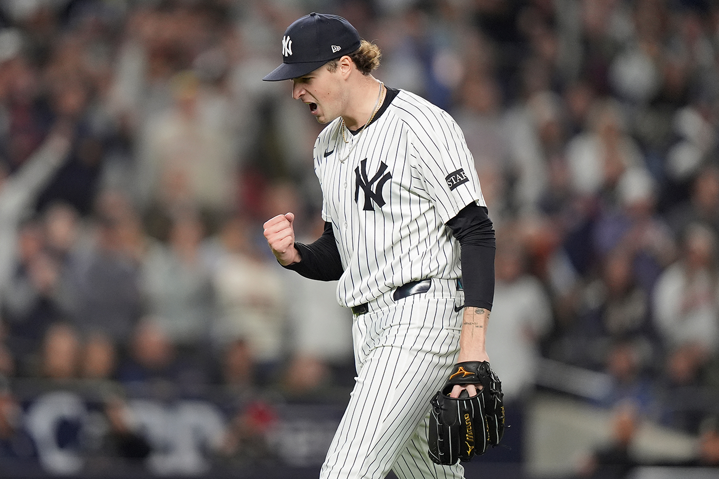 New York Yankees pitcher Cam Schlittler pumps his fist as he walks off the field.