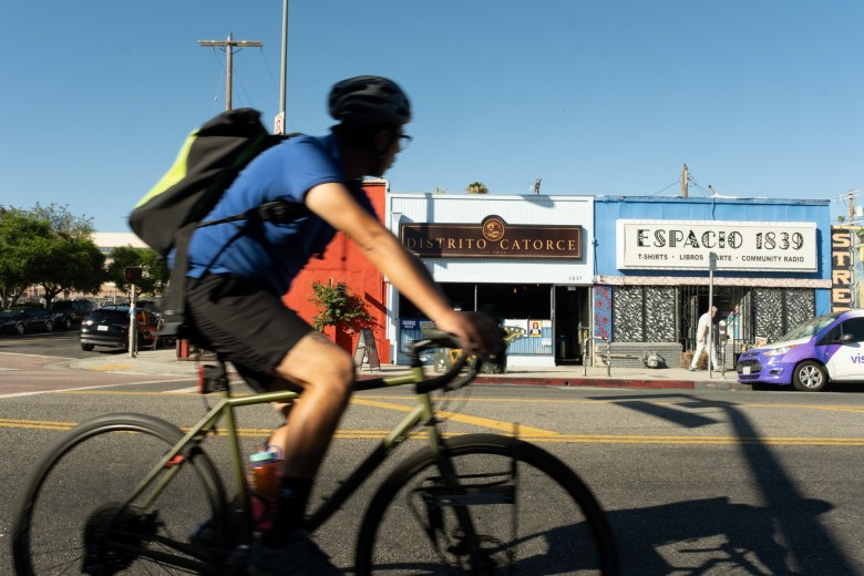 A cyclist passes by the 1st Street business corridor