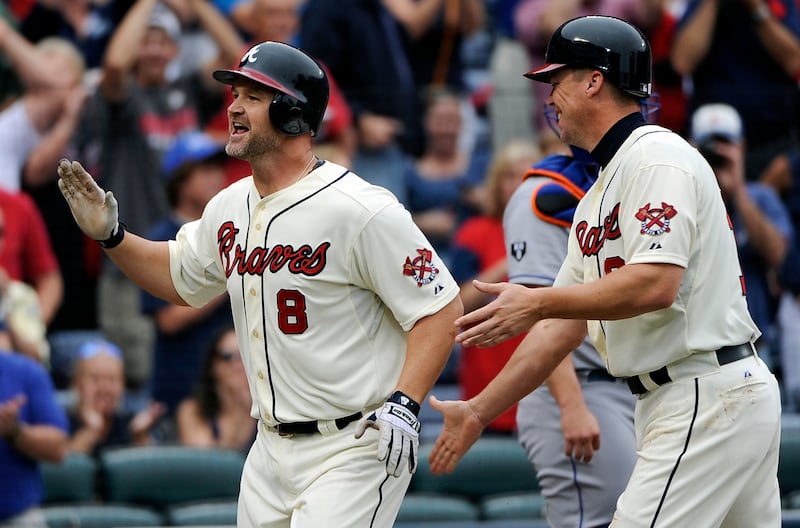 Atlanta Braves' David Ross (8) homers and is congratulated at the plate by teammate Chipper Jones (10) during the second inning of their baseball game against the New York Mets at Turner Field Sunday, Sept. 30, 2012, in Atlanta.    (AP Photo/David Tulis)