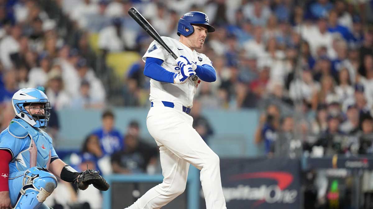 Los Angeles Dodgers first baseman Freddie Freeman (5) hits a single against the Toronto Blue Jays in the sixth inning during game four of the 2025 MLB World Series at Dodger Stadium. 