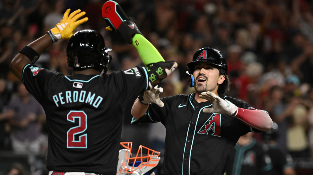 Corbin Carroll #7 of the Arizona Diamondbacks celebrates his grand slam with Geraldo Perdomo #2 aga...