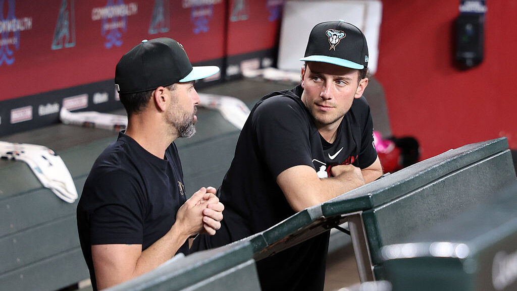 Pitcher Brandon Pfaadt #32 of the Arizona Diamondbacks talks with pitching coach Brian Kaplan...