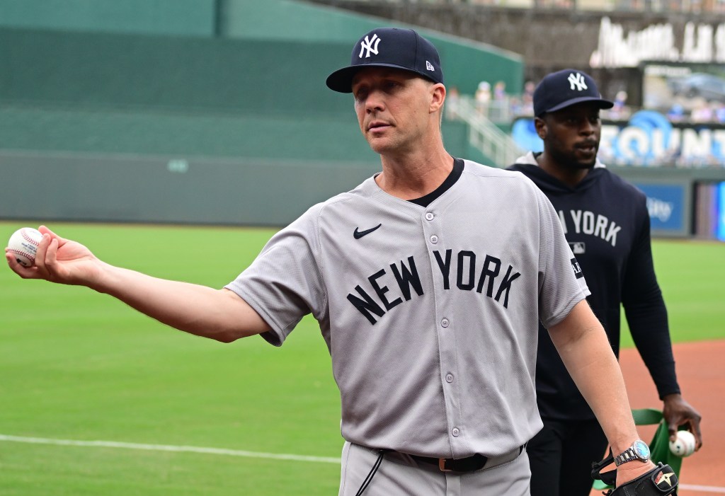 New York Yankees first base coach Travis Chapman (75) throws a ball into the stands before a Major League Baseball game between the New York Yankees and the Kansas City Royals on June 11, 2025, at  Kauffman Stadium, Kansas City, MO. 