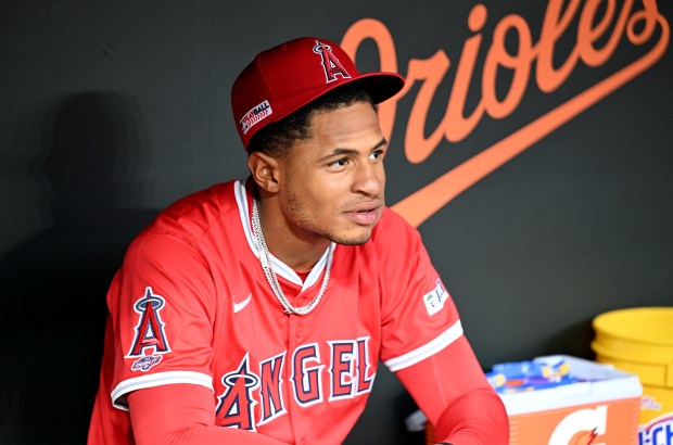 Angels second baseman Christian Moore sits in the dugout before...
