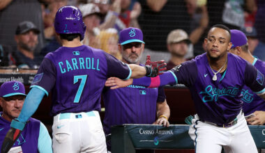 Ketel Marte #4 high fives Corbin Carroll #7 of the Arizona Diamondbacks...