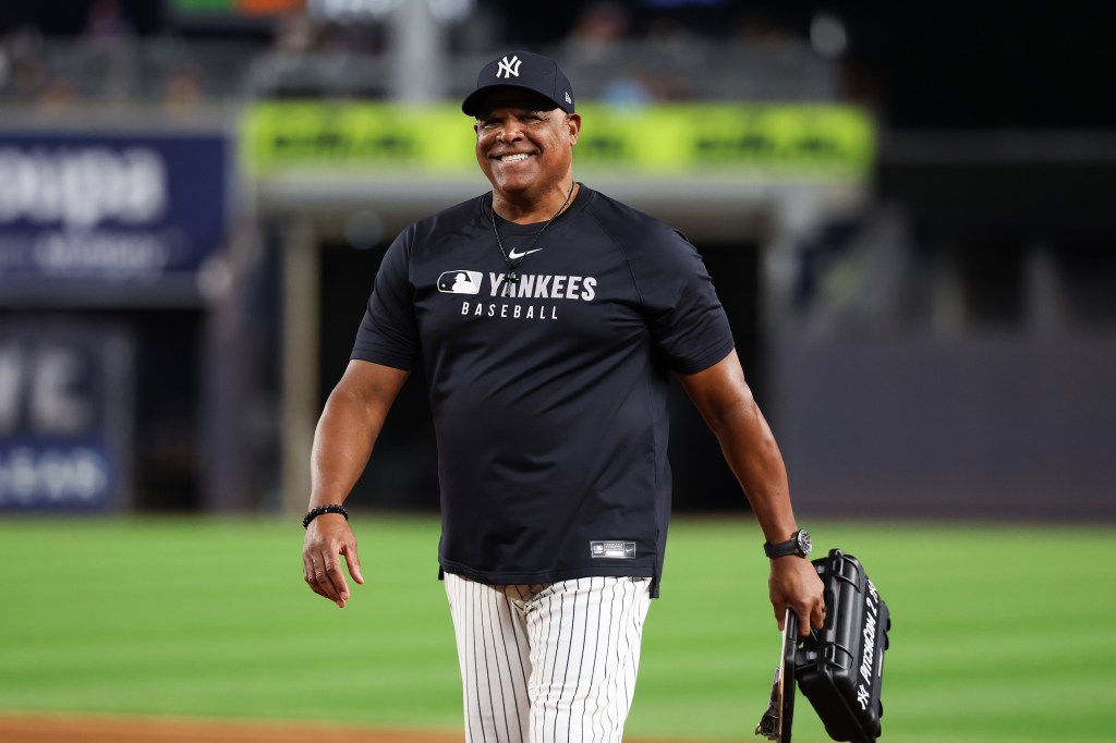 Bullpen Coach, Mike Harkey #60 of the New York Yankees smiles during the game against the Washington Nationals at Yankee Stadium on August 26, 2025 in New York, New York. 