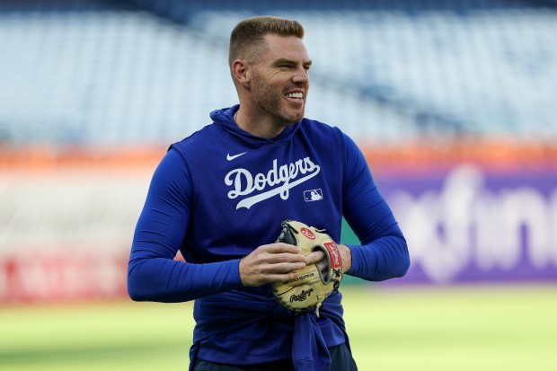 Dodgers first baseman Freddie Freeman smiles during warmups before playing...