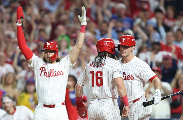 The Philadelphia Phillies’ Brandon Marsh (16) celebrates with teammate Max...