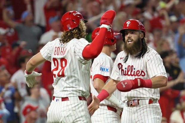 The Philadelphia Phillies’ Brandon Marsh, right, celebrates with teammate Alec...