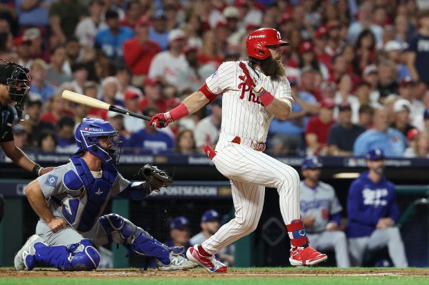 The Philadelphia Phillies’ Brandon Marsh hits a single in the...