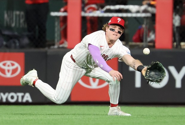 Philadelphia Phillies center fielder Harrison Bader dives to make a...