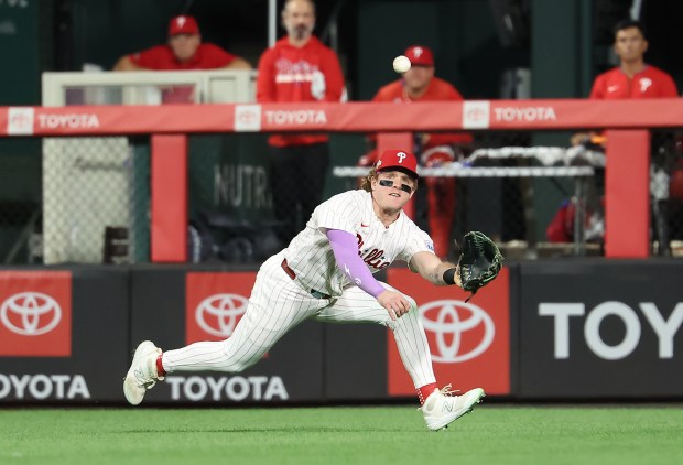 Philadelphia Phillies center fielder Harrison Bader dives to make a...