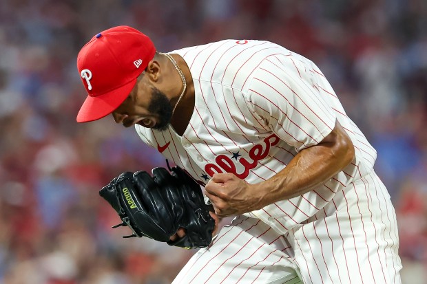 Philadelphia Phillies starting pitcher Cristopher Sanchez reacts after getting the...