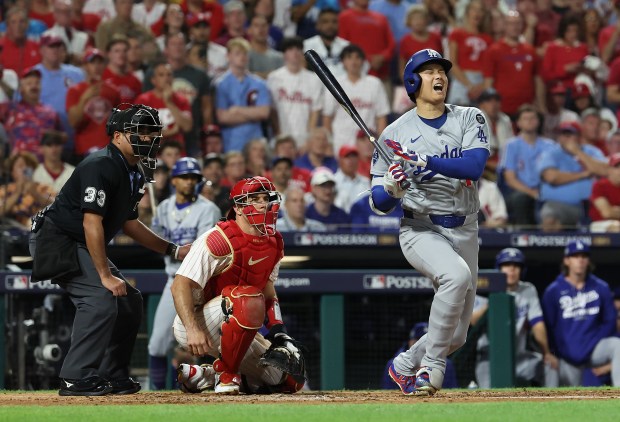 Dodgers star Shohei Ohtani reacts at bat in the third...