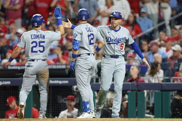 The Dodgers’ Tommy Edman (25), Alex Call (12) and Freddie...