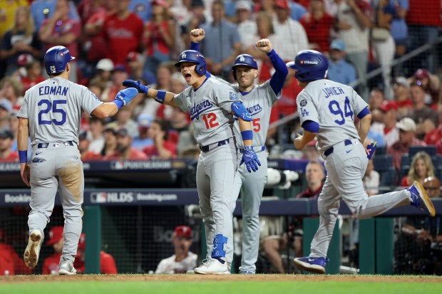 The Dodgers’ Tommy Edman (25), Alex Call (12) and Freddie...