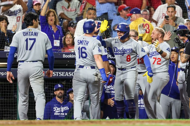 The Dodgers’ Will Smith (16) and Kike Hernandez (8) celebrate...