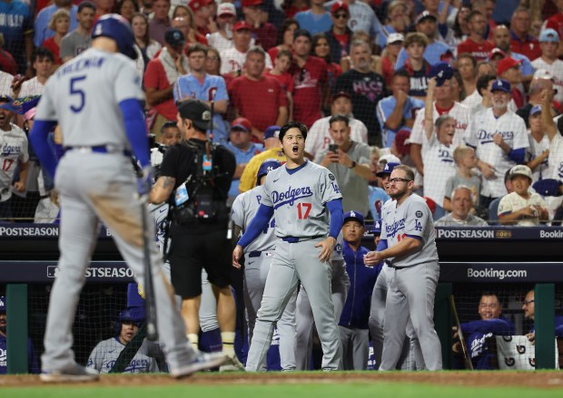 Dodgers star Shohei Ohtani (17) reacts after teammate Teoscar Hernandez...