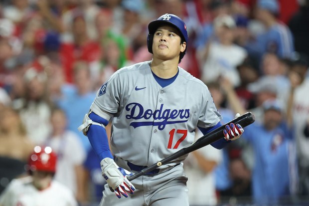 Dodgers star Shohei Ohtani reacts to striking out in the...