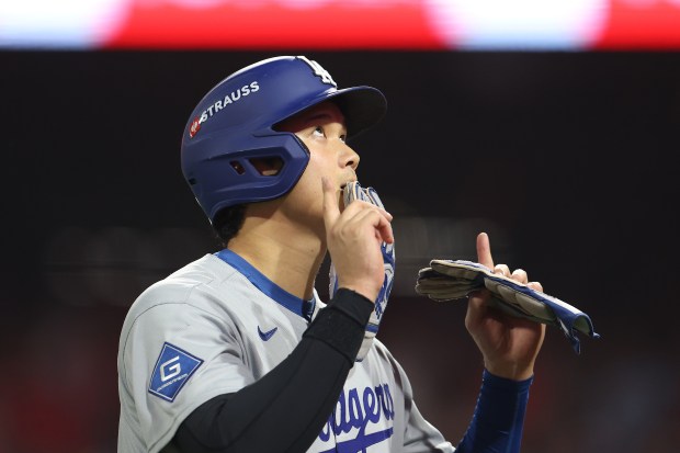 Dodgers star Shohei Ohtani reacts during the ninth inning against...