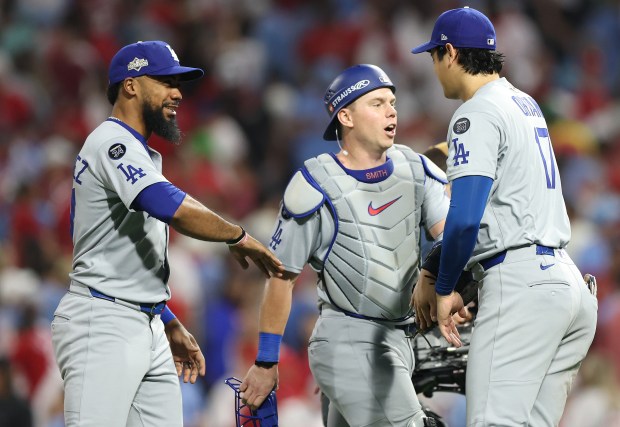Dodgers outfielder Teoscar Hernandez, left, catcher Will Smith, center, and...
